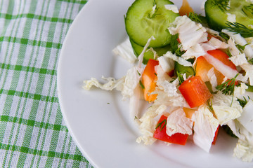 White plate with fresh vegetable salad
