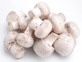 Handful of champignons on a white background