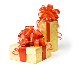 Two gold gift boxes with red ribbons