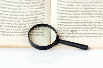 Magnifying glass and a book.