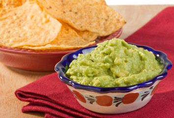 Rich creamy fresh avocado guacamole with tortilla chips