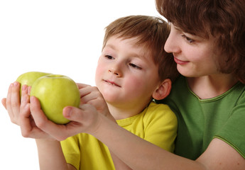 Fototapeta premium Mother gives son an apple