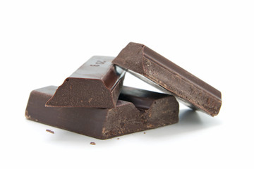Pieces of broken chocolate isolated on white background
