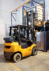 forklift loader stacking in warehouse