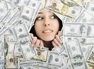 woman looking trought hole on money bacground