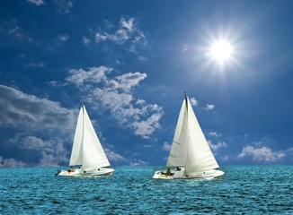 Fototapeta premium two white sail boats in a sea