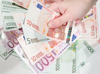 Female hand with money against money