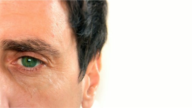 Green eye close-up caucasian man white background isolated video