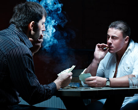 Two gamblers smoking and drinking
