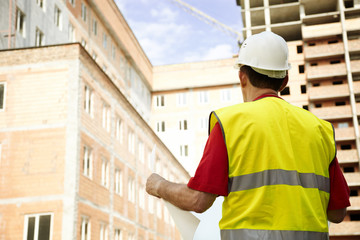Building Inspector Reviewing Blueprints