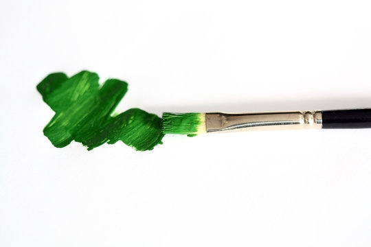 Brush With Green Paint On The White Background