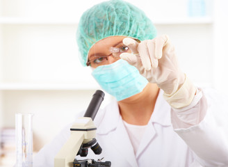 Scientific researcher using a microscope in a laboratory