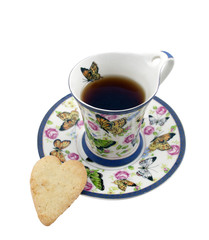 Cup of tea with a cookie in the form of a heart