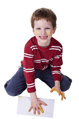 Children playing with paint, stamping his hand on a white sheet