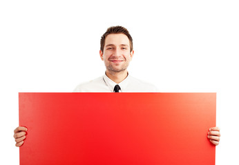 Proud businessman behind red sign
