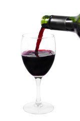 A bottle pouring red wine into a clear glass isolated on white