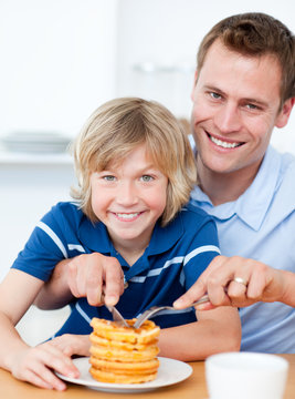 Smiling Father And His Son Eating Waffles