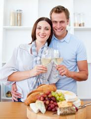 Obraz na płótnie Canvas Smiling lovers drinking white wine