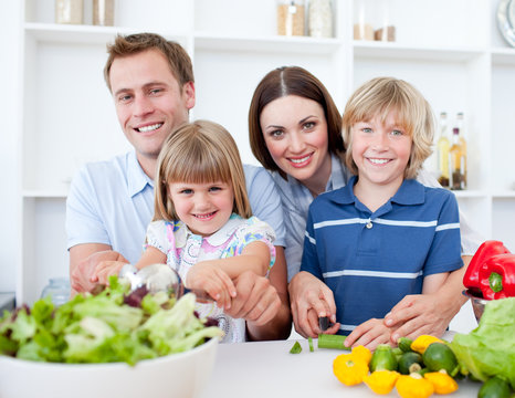 Cheerful young family cooking together