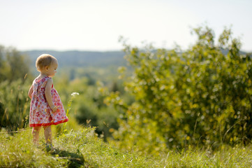 Little baby girl on the edge of a cliff