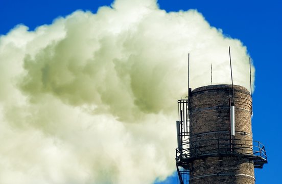 smog from a bipe on a blue sky background