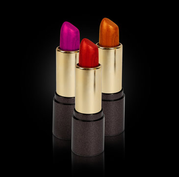 three colored lipsticks