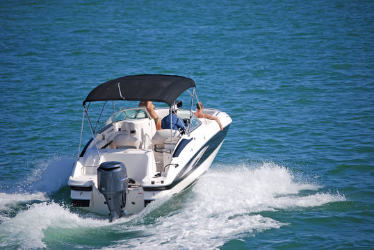 Outboard Motorboat with Blue Canvas Canopy