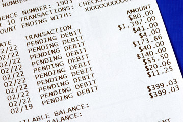 Banking slip after an ATM transaction isolated on blue