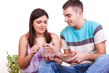 couple sitting on the floor and eating