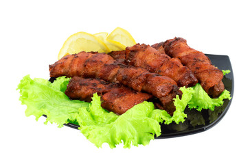 Roasted meat, wrapped in bacon on the dish