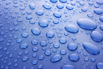 Blue water drops background with big and small drops