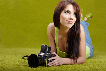 woman with camera on green spring background