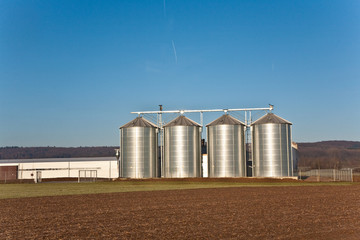beautiful landscape with silo and snow white acre with blue sky © travelview