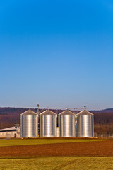beautiful landscape with silo and snow white acre with blue sky