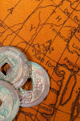 Chinese coins over antique map