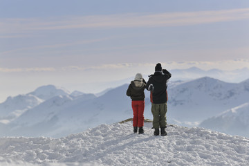 snowboarder's couple on mountain's top