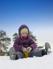 Fototapeta na wymiar Little child sliding in the snow