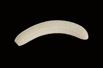 Peeling banana on the black surface.