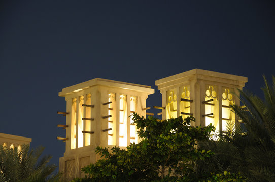 Arabic Wind Towers illuminated at night. Dubai, UAE