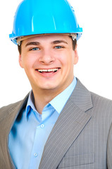 engineer with blue hard hat standing confidently