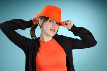 white woman arranging orange hat