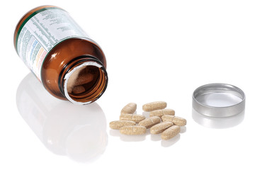 open bottle and vitamins