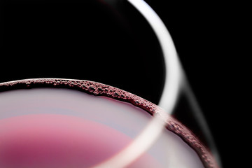 Red wine bubbles in glass. Selective focus.