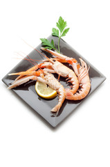 scampi on dish with lemon and parsley