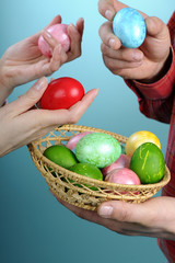 human hands choosing easter eggs