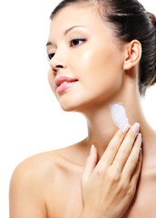 female  applying  moisturizer  cream on neck