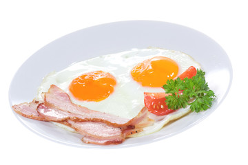 plate with fried egg, bacon vegetables