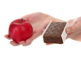 Hands holding up an apple and cookie