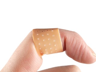 Band-aid on crooked finger onto white background