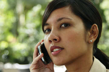 A female young executive talking on the cellphone outdoors